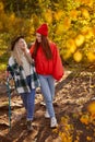 Two attractive women walk together in the forest