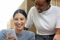 Check this out. two attractive young businesswomen looking at a cellphone together in the office. Royalty Free Stock Photo