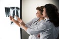 Two attractive young doctors looking at x-ray Royalty Free Stock Photo