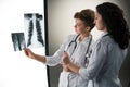 Two attractive young doctors looking at x-ray Royalty Free Stock Photo