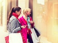 Two attractive young female friends enjoying a day out shopping, colorised image