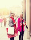 Two attractive young female friends enjoying a day out shopping, colorised image