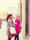 Two attractive young female friends enjoying a day out shopping, colorised image