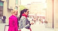 Two attractive young female friends enjoying a day out shopping, colorised image Royalty Free Stock Photo