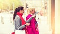 Two attractive young female friends enjoying a day out shopping, colorised image