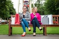 Two attractive young female friends enjoying a day out after successful shopping Royalty Free Stock Photo
