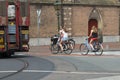 Two attractive young, walking bicycle