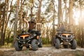 Two atv riders in helmets raise their hands up Royalty Free Stock Photo