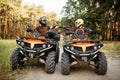 Two atv riders hits fists for good luck, back view Royalty Free Stock Photo