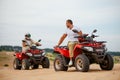Two atv riders racing in desert sands Royalty Free Stock Photo