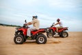 Two atv riders racing in desert sands Royalty Free Stock Photo