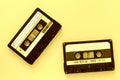 Two audio tape cassettes, top view. Old technology concept. Yellow color Royalty Free Stock Photo