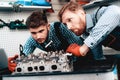 Two Auto Mechanics Are Checking Detail In Garage. Royalty Free Stock Photo