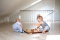 Two babies boy and girl playing chess on the white wooden floor at home Royalty Free Stock Photo