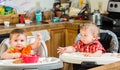 Two Babies Eat Breakfast Royalty Free Stock Photo