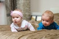 Two babies lying on belly and grimacing Royalty Free Stock Photo