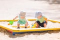 Two baby boys playing with sand Royalty Free Stock Photo