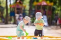 Two baby boys playing with sand Royalty Free Stock Photo