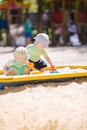 Two baby boys playing with sand Royalty Free Stock Photo