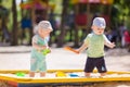 Two baby boys playing with sand Royalty Free Stock Photo