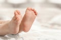 two baby legs on the background of white bed linen. Ukrainian newborn. baby`s little toes Royalty Free Stock Photo