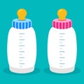 Two baby milk bottles blue boy and pink girl Royalty Free Stock Photo