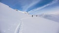 Two backcountry skiers on a tour in the Austrian Alps and putting in new tracks on their way to the summit Royalty Free Stock Photo