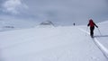 Two backcountry skiers on a tour in the Austrian Alps and putting in new tracks on their way to the summit Royalty Free Stock Photo