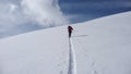 Two backcountry skiers on a tour in the Austrian Alps and putting in new tracks on their way to the summit Royalty Free Stock Photo