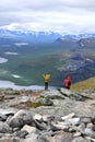Two backpack hikers high on fell mountain top in Lapland Scandinavia
