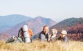 Two backpackers Father and son hikers rest on mountain hill wit