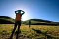 Backpacking women hiking in sunrise mountains