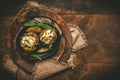 Two baked potatoes with mushrooms, sour cream and cheese on a rustic wooden background Royalty Free Stock Photo