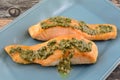 Baked salmon fish fillets with pesto sauce