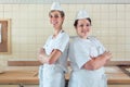 Two baker women standing proud in their bakery Royalty Free Stock Photo