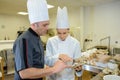 Two bakers talking in kitchen