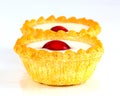 Two Bakewell Tarts with white icing and a red cherry. Royalty Free Stock Photo