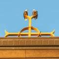 Two bald eagles on Catholic church steeple on top of the Christian cross at Annunciation Church in South Minneapolis