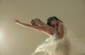 Two ballet dancers dance against white flour cloud in air Royalty Free Stock Photo