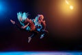 Two ballet girls in tight-fitting costumes jumping on black background with their long hair down, silhouettes illuminated by color Royalty Free Stock Photo