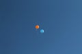 Two balloons flying through the blue sky Royalty Free Stock Photo