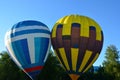 Two balloons on the ground, white-blue-red and yellow-blue hot air balloon Royalty Free Stock Photo