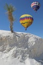 Two balloons over white sand