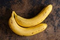 Two bananas on abstract wooden background. Top view Royalty Free Stock Photo