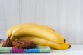 Two bananas and chocolate cookies on a tartan kitchen towel.