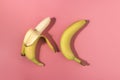 Two bananas on pink background with contrast shadows