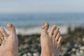 Two bare feet against the sea is out of focus. Royalty Free Stock Photo