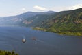 Two barges on the Columbia River with the hilly banks