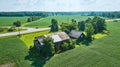 Two barns falling apart on soybean farm aerial summer day