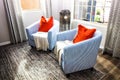 Two Barrel Chairs With Orange Pillows Royalty Free Stock Photo